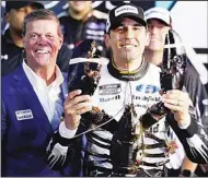  ?? (AP) ?? Aric Almirola smiles as he holds up a giant lobster after winning the NASCAR Cup Series auto race, on July 18, in Loudon, N.H. At left is Dave McGrath, general manager of New Hampshire Motor Speedway.