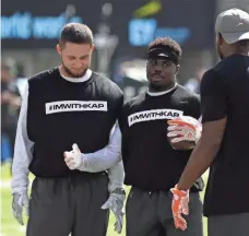  ?? ROBERT DEUTSCH, USA TODAY SPORTS ?? Miami receiver Jakeem Grant, center, displays his support of Colin Kaepernick on Sunday.