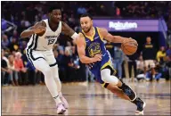  ?? JOSE CARLOS FAJARDO — BAY AREA NEWS GROUP ?? The Warriors' Stephen Curry (30) drives against the Grizzlies' Jaren Jackson Jr. (13) in Game 6 of a second-round playoff series at Chase Center in San Francisco on Friday.