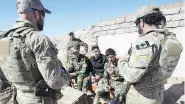  ?? RYAN REMIORZ / THE CANADIAN PRESS FILES ?? Canadian special forces soldiers speak with Kurdish fighters in 2017 in northern Iraq. Up to 250 Canadian troops will be part of a new NATO mission in Iraq.