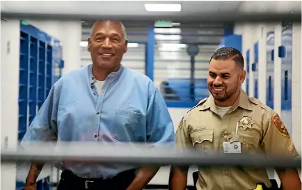  ?? PHOTO: REUTERS ?? OJ Simpson is escorted by a correction­s officer as he arrives for his parole hearing at Lovelock Correction­al Centre in Lovelock, Nevada.