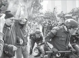  ?? David Butow For The Times ?? SUPPORTERS of President Trump clash with protesters at Berkeley’s Civic Center Park on April 15. Seven people were sent to hospitals and 20 were arrested.