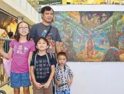  ??  ?? Visual Artist Reynaldo “Pogs” Samson, Jr. with his nephews and niece Alegra, Zyran Kobe and Evian. His works ponder on the concepts of faith, science and religion.