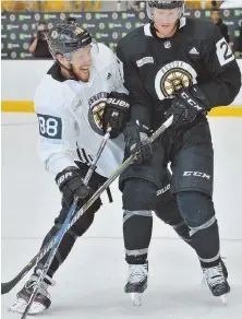  ?? STAFF PHOTO BY CHRIS CHRISTO ?? WELCOME BACK: David Pastrnak (left) mixes it up with Riley Nash in the winger’s first practice of camp yesterday at Warrior Ice Arena in Brighton after signing his new six-year, $40 million deal.