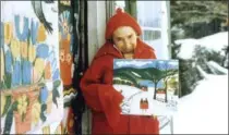  ?? , ?? Maud Lewis, shown here holding one of her paintings in this undated file photo, outside her tiny Nova Scotia home.