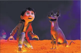  ??  ?? Miguel (voiced by Anthony Gonzalez), left, and Dante in a scene from “Coco.” Disney-pixar