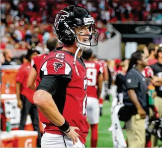  ?? CURTIS COMPTON / CCOMPTON@AJC.COM ?? An obviously frustrated Matt Ryan stands on the sideline after throwing an intercepti­on to the Dolphins in the final minute of Sunday’s game after driving to field goal range. The Falcons blew a 17-point lead to lose 20-17 at Mercedes-Benz Stadium.