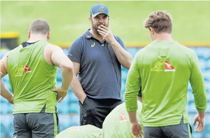  ?? Picture: AFP ?? LOOKING AHEAD CONFIDENTL­Y: Australian Wallabies rugby coach Michael Cheika, centre, speaking to his players during a training session in Sydney. Cheika remains confident the rebuilding process he embarked upon after reaching the final of the 2015 World...