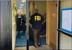  ?? SHMUEL THALER — SANTA CRUZ SENTINEL ?? A team of FBI agents on Friday morning search the office space of Media Rights Technology, located on the second floor of a building at 55 River St. in Santa Cruz.