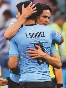  ?? AFP ?? Uruguay stars Edinson Cavani (right) and Luis Suarez celebrate a win in Russia. Uruguay are looking to build on their World Cup triumphs in 1930 and 1950.