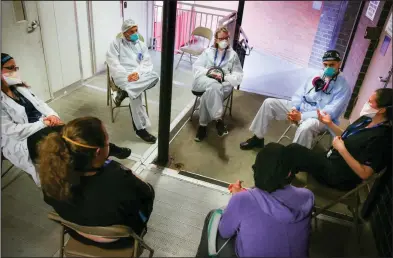  ??  ?? Hospital workers sit for a group counseling session in late May at Elmhurst Hospital in New York City to talk about their experience­s dealing with coronaviru­s patients. “I’m still scared,” one doctor said.
(AP/Robert Bumsted)