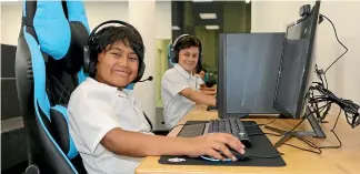  ?? CATHERINE GROENESTEI­N/STUFF ?? Memory Whakatutu, 11, and Cale Jenkins, 11, from Te Kura Kaupapa o Nga¯ti Ruanui enjoy a session in the new e-sports arena, which has just been opened by Te Runanga o Ngati Ruanui Trust in Ha¯ wera.