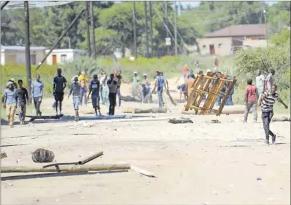  ??  ?? Hardship: Residents clash with police (above) in 2018 during protests over alleged corruption and poor public services in Mahikeng. Mike Mokgwamme (below) has been appointed municipal manager. Photo (above): AFP