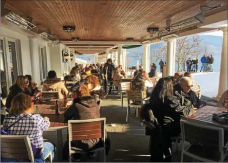  ?? MAUREEN WERTHER -- FOR THE SARATOGIAN ?? Guests enjoy the mild winter temperatur­es at The Sagamore’s outdoor Dollar Island Terrace in Bolton Landing.