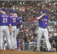  ?? John Amis / Associated Press ?? Mets pitcher Zack Wheeler leaves Tuesday night’s game against the Braves in Atlanta.