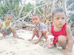  ??  ?? These little children play along the Kavewa shoreline which is littered with skeleton of plants uprooted by strong surges of a recent storm that affected the island.
Picture SOPHIE RALULU