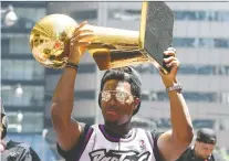  ?? DAN HAMILTON/USA TODAY SPORTS/FILES ?? Toronto Raptors guard Kyle Lowry shows off the Larry O’brien Trophy to fans during the victory parade through downtown Toronto on June 17 to celebrate their historic NBA title.