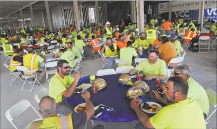  ?? Hearst Connecticu­t Media file photo ?? Constructi­on workers enjoy a lunch from Bobby Q’s restaurant during a General Growth Properties contractor appreciati­on event at SoNo Collection constructi­on site in May in Norwalk.