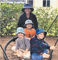  ?? Pictures: Contribute­d ?? FUN DAY: Judy Cuskelly gives students (from left) Beau Dagg, Ethan Wright and Grayson Butler a push on the swing.