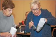  ?? ROXANNE RICHARDSON - DIGITAL FIRST MEDIA ?? Barbara Conrad, Muhlenberg resident, dusts for fingerprin­ts on a glass during the Citizen Police Academy on March 6.