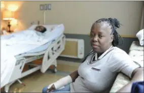  ??  ?? Chevelle Washington, right, sits in the hospital room of her sister, Chelette Price, in Houston on Aug. 13. One profound change wrought by Hurricane Katrina was the splitting of families as a mass evacuation from chaotic New Orleans sent thousands,...