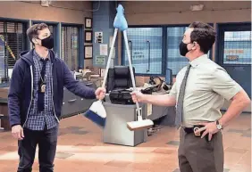  ?? PROVIDED BY NBC ?? Jake (Andy Samberg, left) and Charles (Joe Lo Truglio) adapt high-fives to the pandemic in the Season 8 premiere of “Brooklyn Nine-Nine.”