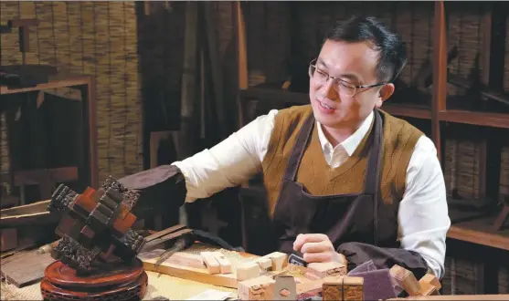 ?? PROVIDED TO CHINA DAILY ?? Li Hao works in his workshop on the Luban lock in Tengzhou, Shandong province.