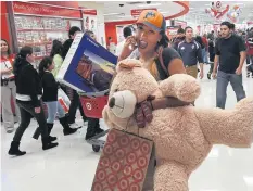  ?? AFP ?? Shoppers leave a Target store after the start of a Black Friday sale that started a day earlier on Thanksgivi­ng evening in Los Angeles.