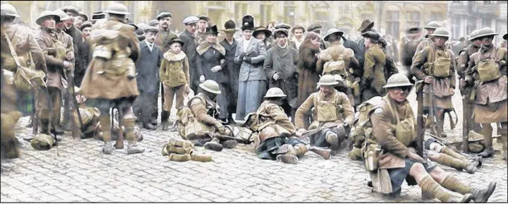  ?? SUBMITTED PHOTO ?? Members of the 42nd Battalion resting in the town square in Mons on the morning of Nov. 11, 1918, just a few minutes after hostilitie­s ceased.