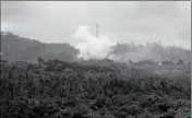  ?? ASSOCIATED PRESS ?? VOLCANIC GASES AND ASH RISE from recent lava fissures near Pahoa, Hawaii, on Monday. People nixing vacations to Hawaii’s Big island has cost the tourism industry millions of dollars as the top attraction, Kilauea volcano, keeps spewing lava.