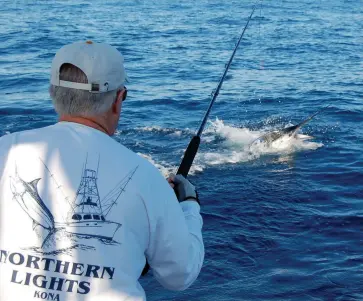  ??  ?? Nick Smith battles a lit-up striped marlin on fly (below). Cole Watkins and Smith handle a doublehead­er in the cockpit of
Old Reliable (above).