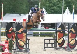  ??  ?? Harry Charles and Vivaldi Du Dom take the junior grand prix crown