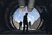  ?? ASSOCIATED PRESS FILE PHOTO ?? People enter the south portal of Yucca Mountain during a 2015 congressio­nal tour of the proposed radioactiv­e waste dump near Mercury, Nev., 100 miles northwest of Las Vegas. A bill to restart the facility passed a House panel Wednesday.