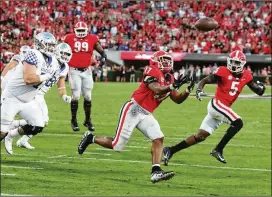  ?? CURTIS COMPTON/AJC 2021 ?? Linebacker Nakobe Dean (17), captain of UGA’S top-ranked national championsh­ip defense and the Butkus Award winner, was projected as a late first-round selection but fell to No. 83 overall in third round of the NFL draft last week.