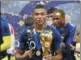  ?? REUTERS ?? Kylian Mbappe poses with the World Cup trophy after Sunday’s victory.