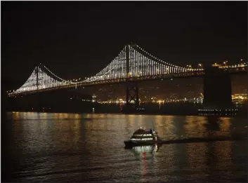  ?? PHOTOS BY JIM WILSON — THE NEW YORK TIMES ?? The Bay Bridge is illuminate­d by LED lights in San Francisco on Feb. 28. The artwork created by Leo Villareal, known as the Bay Lights, was turned off on Sunday after its creators said it could no longer endure the region’s harsh conditions. They hope to raise $11 million to refurbish it.