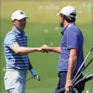  ?? David J. Phillip / Associated Press ?? Jordan Spieth and Scottie Scheffler meet on the range during a practice day for the Masters on Monday in Augusta, Ga.