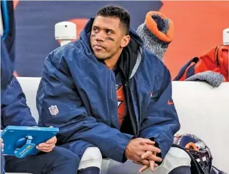  ?? AP PHOTO/DAVID ZALUBOWSKI ?? Denver Broncos quarterbac­k Russell Wilson sits on the bench during a home game against the Los Angeles Charger on Dec. 31. After two underachie­ving seasons, the former Seattle Seahawks star’s time with the Broncos will soon be up as they plan to cut him next week when the NFL’s new business year begins.
