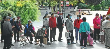  ?? LI ZIHENG / XINHUA ?? Residents of Qingdao, Shandong province, line up for COVID-19 tests on Tuesday. Over 4 million nucleic acid test samples had been collected as of 3:30 pm on Tuesday after the city activated a plan on Monday to conduct citywide testing, officials said.