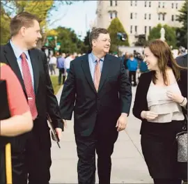  ?? Drew Angerer Getty Images ?? SHAUN McCUTCHEON, the lead plaintiff, leaves the Supreme Court building in Washington. Chief Justice John G. Roberts Jr. holds the swing vote in the case.