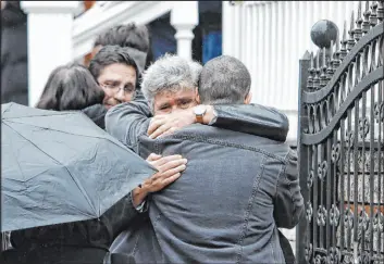  ?? Giannis Papanikos
The Associated Press ?? Mourners hug during the funeral of 23-year old Ifigenia Mitska in Northern Greece on Saturday. Over 50 people died when a passenger train hit a freight carrier Tuesday.