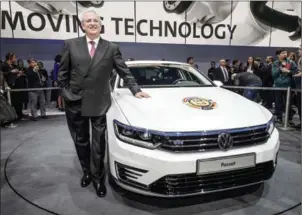  ?? FABRICE COFFRINI/AFP ?? Then chairman of Volkswagen Group, Martin Winterkorn, poses with the Car of the Year 2015, a Volkswagen Passat.