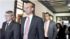  ??  ?? Head of the European Union (EU) delegation to Portugal Jurgen Kroger (L) and head of the European Central Bank (ECB) delegation to Portugal Rasmus Ruffer (C) leave after a meeting with president of the Portuguese Parliament Assuncao Esteves at the...