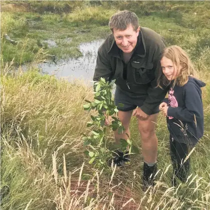  ??  ?? Chairman Colin Tyler, with daughter Scarlett, 7, checks their new wetland.