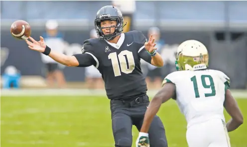  ?? REINHOLD MATAY/ USA TODAY SPORTS ?? Central Florida quarterbac­k McKenzie Milton, getting a pass off before South Florida cornerback Ronnie Hoggins can get to him, has accounted for 36 touchdowns this season, throwing for 30.