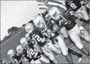  ?? Contribute­d by Gail Conner ?? The Cedartown Bulldogs marched onto the field with locked arms in honor of slain Polk County Police Det. Kristen Hearne on Friday night before the start of the game.