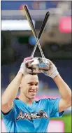  ?? LYNN SLADKY/AP PHOTO ?? Yankees slugger Aaron Judge hoists the trophy after winning Major League Baseball’s Home Run Derby on Monday night at Marlins Park in Miami.