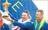  ?? CHRISTIAN PETERSEN/GETTY ?? England’s Justin Rose holds up the Ryder Cup as Sweden’s Henrik Stenson looks on Sunday.