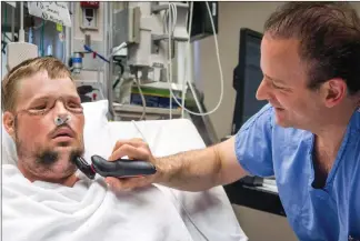  ?? Associated Press photo ?? In this July 3, 2016 photo provided by the Mayo Clinic, Dr. Samir Mardini shaves the face of his patient, Andy Sandness, days after leading a team that performed the first face transplant surgery at the hospital.