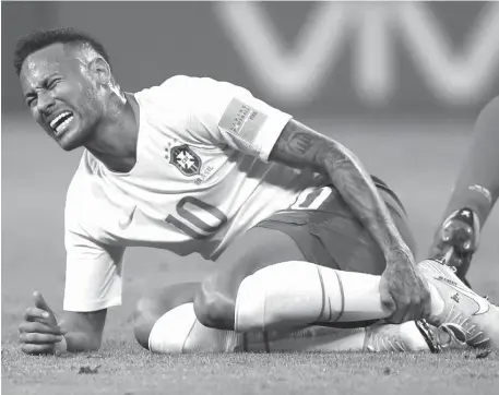  ??  ?? IN this Friday, July 6, 2018 file photo Brazil’s Neymar holds his shinbone during the quarterfin­al match between Brazil and Belgium at the 2018 soccer World Cup in the Kazan Arena, in Kazan, Russia. (AP)